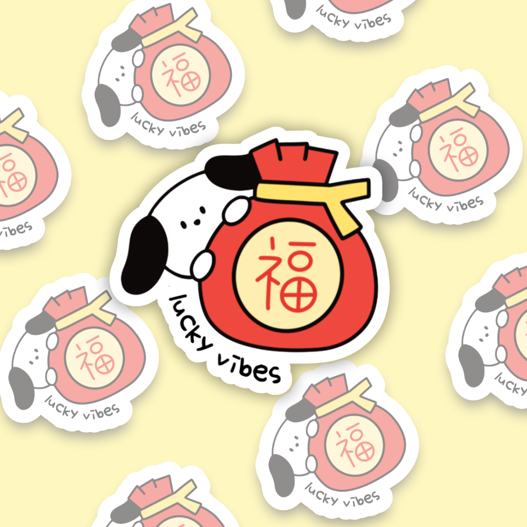 A cute vinyl sticker featuring a black and white cartoon dog hugging a red lucky money pouch with the Chinese character "福" (fu, meaning fortune or blessing). The words “lucky vibes” are written underneath in playful, handwritten text